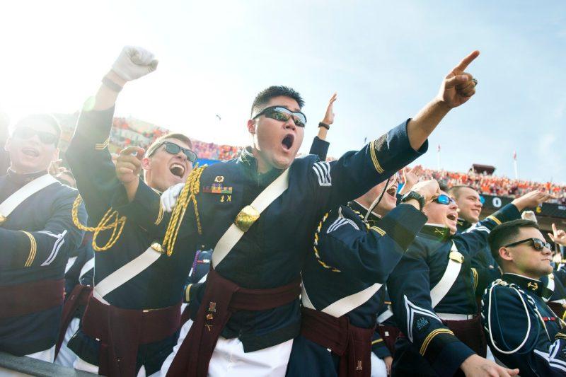 Members of the Corps of Cadets cheer during a football game